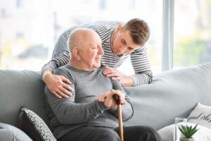 Older adult reviewing a medication reminder beside a tablet and motion-activated hallway light.